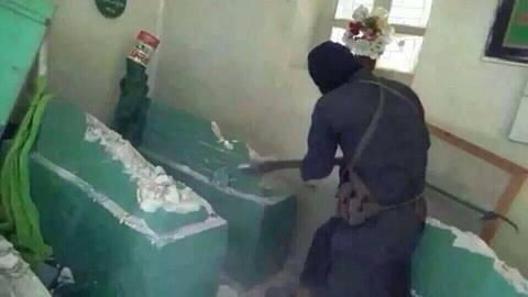 An ISIS man destroying grave of Prophet Younus